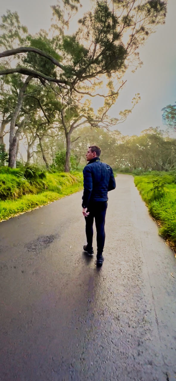 Duan walking along a quiet road under trees