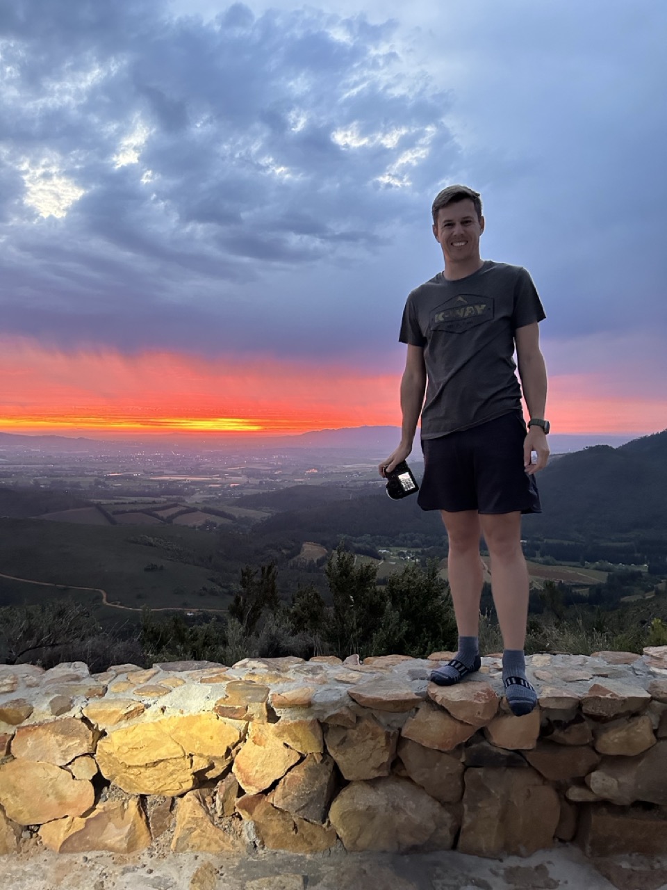 Duan with a camera at sunset